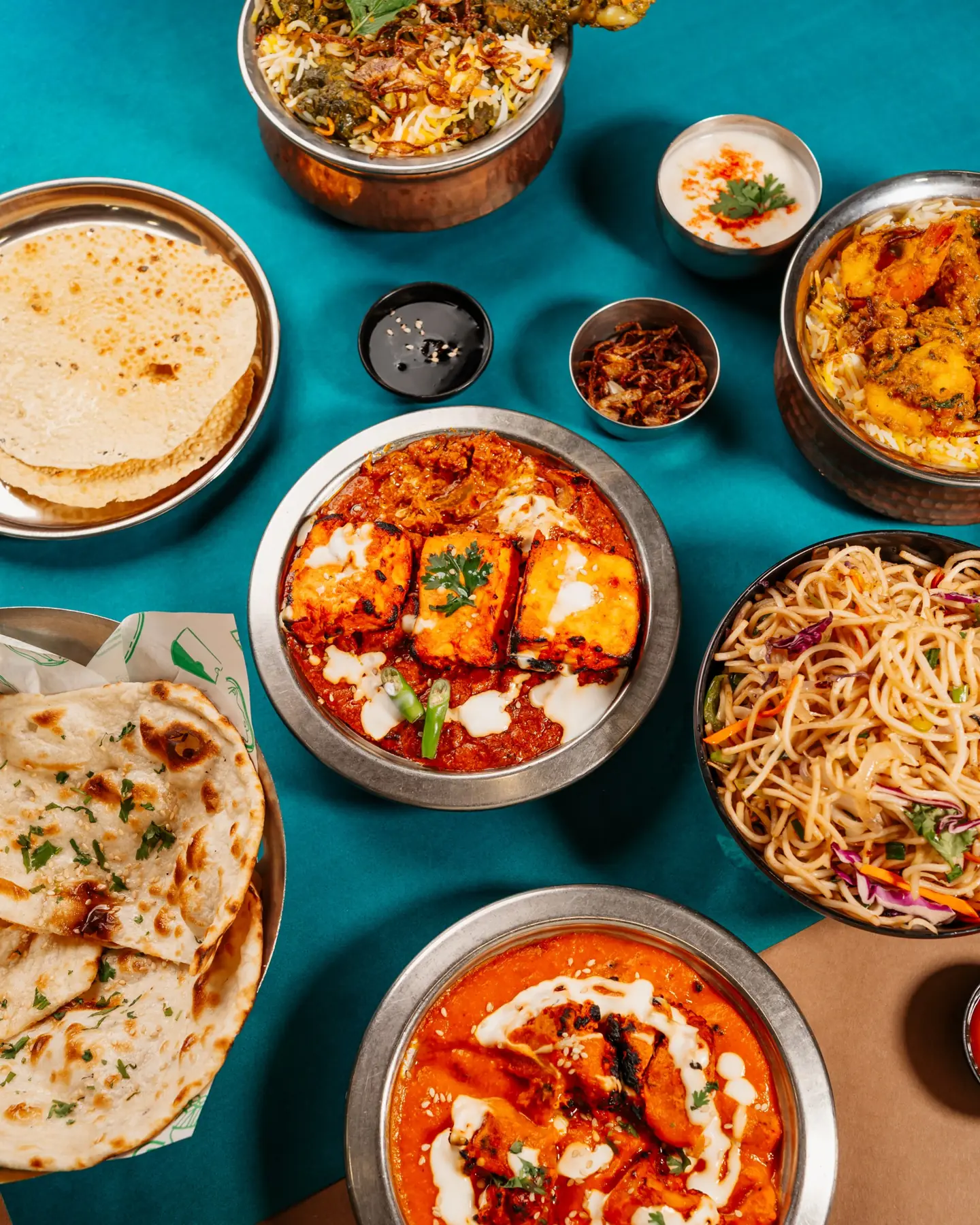 A spread of Park View dishes on teal and kraft paper