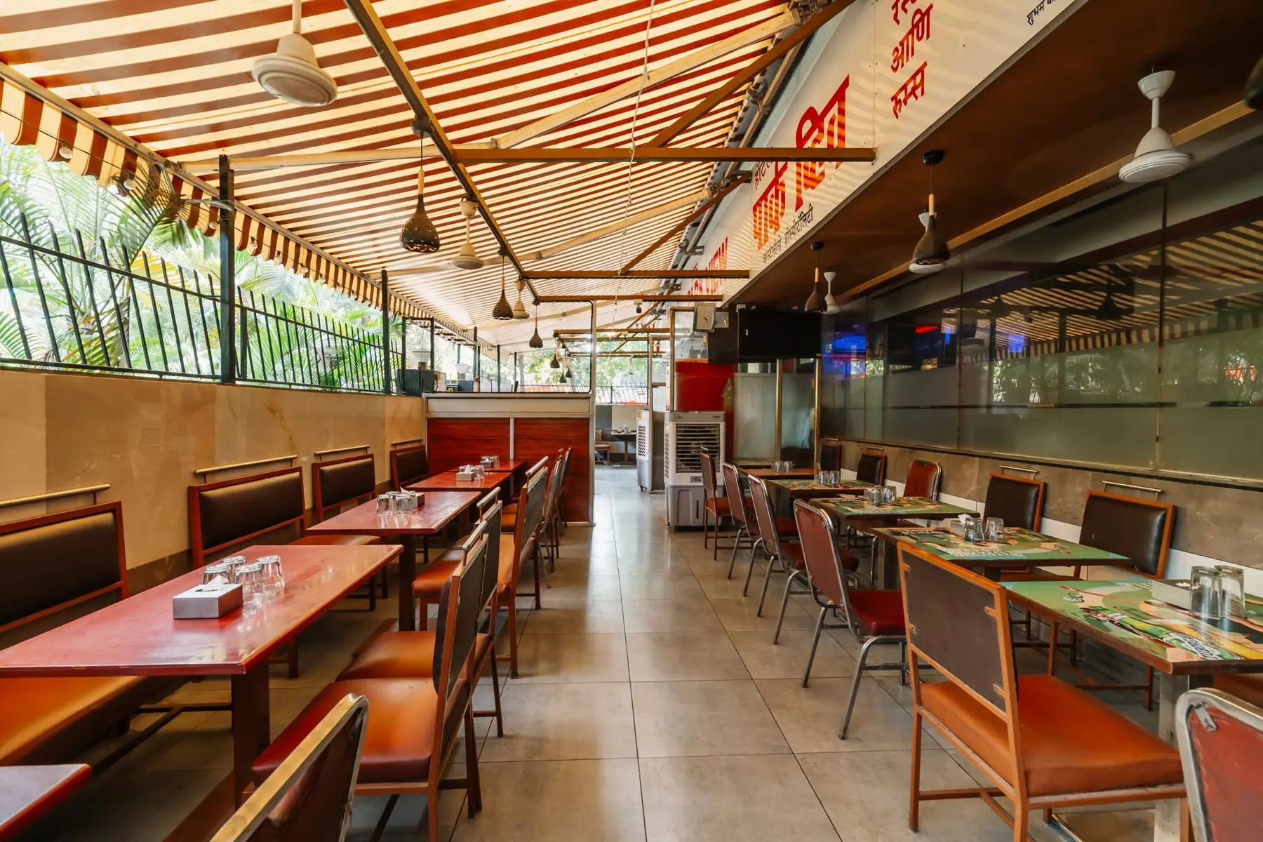 Rows of tables in the restaurant, with the bar at the far end