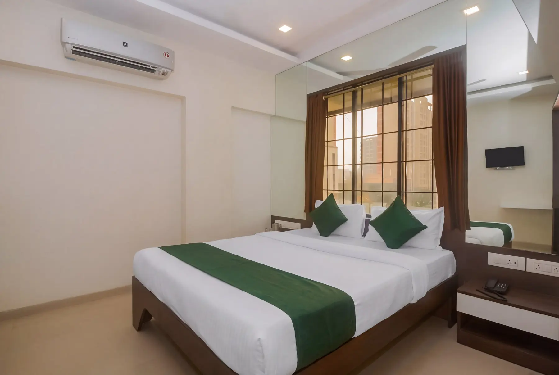 A double room with air conditioning and a wall-mounted TV